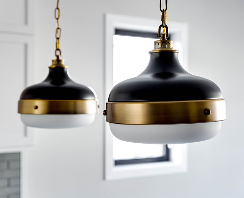New modern light fixtures complement the fresh white paint and trim in this kitchen