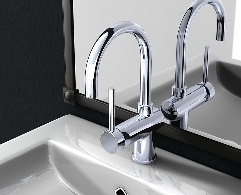 A new bathroom faucet and sink gleam against fresh, dark paint